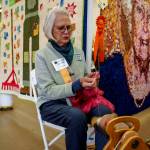 Photo by David Welton
A Whidbey Island Fair volunteer works a spinning wheel in the Burrier Building this year.
