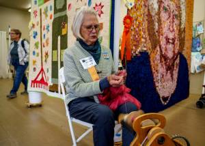 Photo by David Welton
A Whidbey Island Fair volunteer works a spinning wheel in the Burrier Building this year.