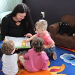 Photo by Sarah Bellis
Ashley Bernales reads a book to Weston, Xayla and Waylon.