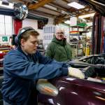 (Photo by David Welton) Senior Technician Alex Neal works on a customers car while Matt Hassrick looks on.