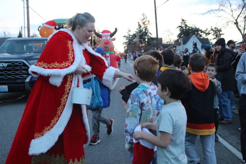 Photo by Marina Blatt
Mrs. Claus hands out candy to eager kids at the Coupeville parade on Dec. 6.