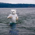 (Photo by David Welton) Kustaa Mansfield got into the spirit by donning a polar bear suit. While some only stayed in the water for about 10 seconds, he lingered and enjoyed the icy atmosphere.