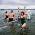 (Photo by David Welton) Swimmers rejoiced in the icy high tide waters of Double Bluff Beach in Freeland on New Years Day.