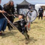 (Photo by Ted Warner Photography) A young boy fights with all his might at the Whdibey Island Ren Faire.