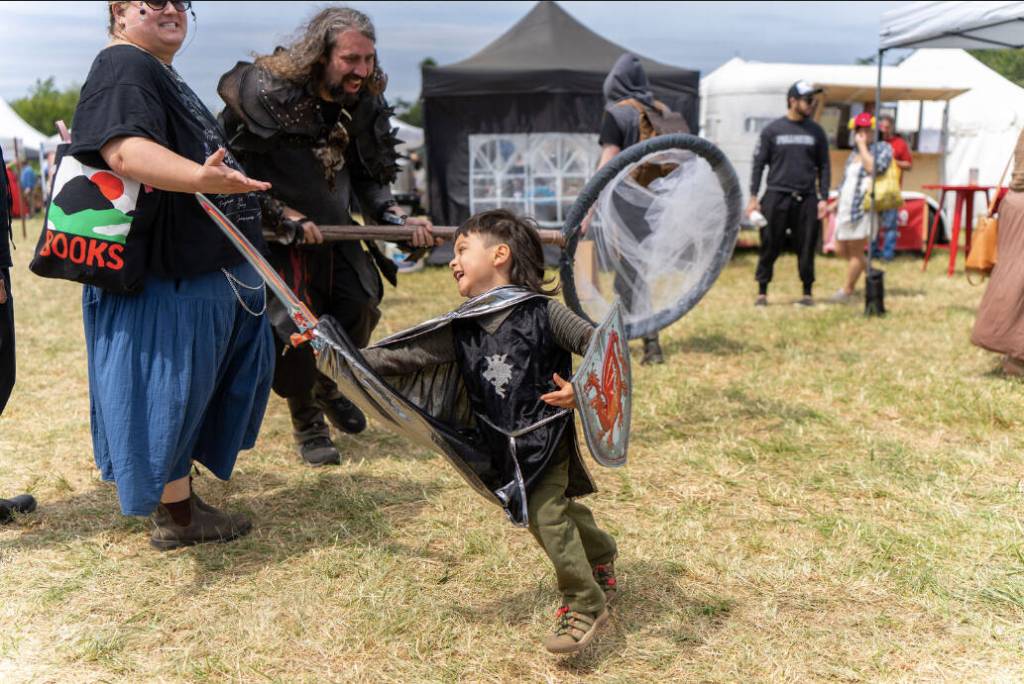 (Photo by Ted Warner Photography) A young boy fights with all his might at the Whdibey Island Ren Faire.