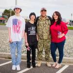 Photo provided. Brandon Doucette smiles with his family members in his millitary uniform. From left are Trey, Tyse, Brandon and Kristi Doucette.