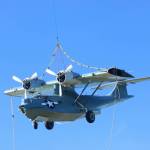 (Photo by Allyson Ballard) The Pacific Northwest Naval Air Museums PBY dangled above downtown Oak Harbor on Wednesday in a uniquely Whidbey spectacle which drew plenty of onlookers.