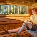 (Photo by David Welton) Maia Rezoski gazes out the window of the mobile sauna, which offers stunning views of nature wherever it is parked on Whidbey.