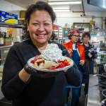 Photo by David Welton. Joan Samson holds up a berries and cream crepe, one of Merriweather Creperies bestsellers.