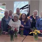 Lions Tom Bond, Mike Hill, Carolyn ODell and Bobbi Lornson, pictured here in club garb, donated the remainder of the tulips.