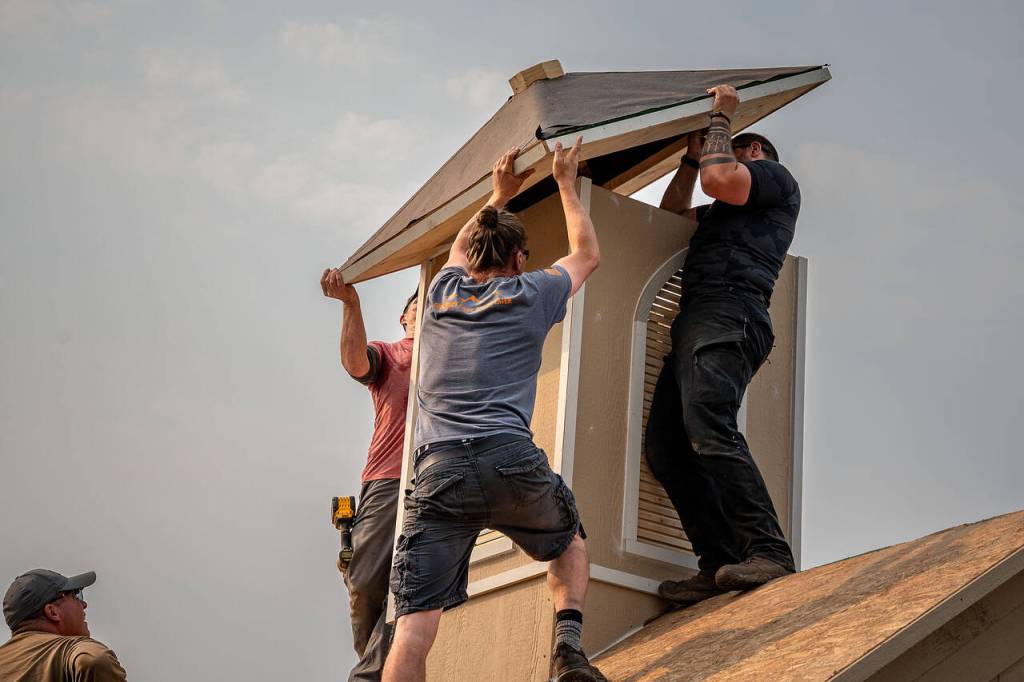 Photos by David Welton. Volunteers work on the finishing touches to the chapel.