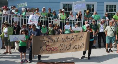 Photo by Robbie Cribbs. Protesters made their feelings clear about the gas station proposal ahead of Mondays Langley City Council meeting.