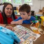 Photo by David Welton. Rocky Hawkins gets some help with Legos during a special event at the Langley Library on Wednesday.