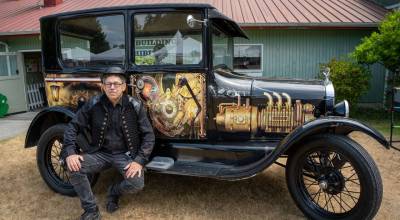 (Photo by David Welton) Visitors to the Whidbey Island Fair had the opportunity to view a 1927 Ford Model T decked out steampunk-themed vinyl wrap alongside its owner, Alan Sands.